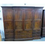 Large 19th century breakfront linen press, with cornice and a dentil frieze over four panelled doors