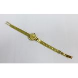 Lady's vintage gold cased Rotary wrist watch on a 14ct gold bracelet strap