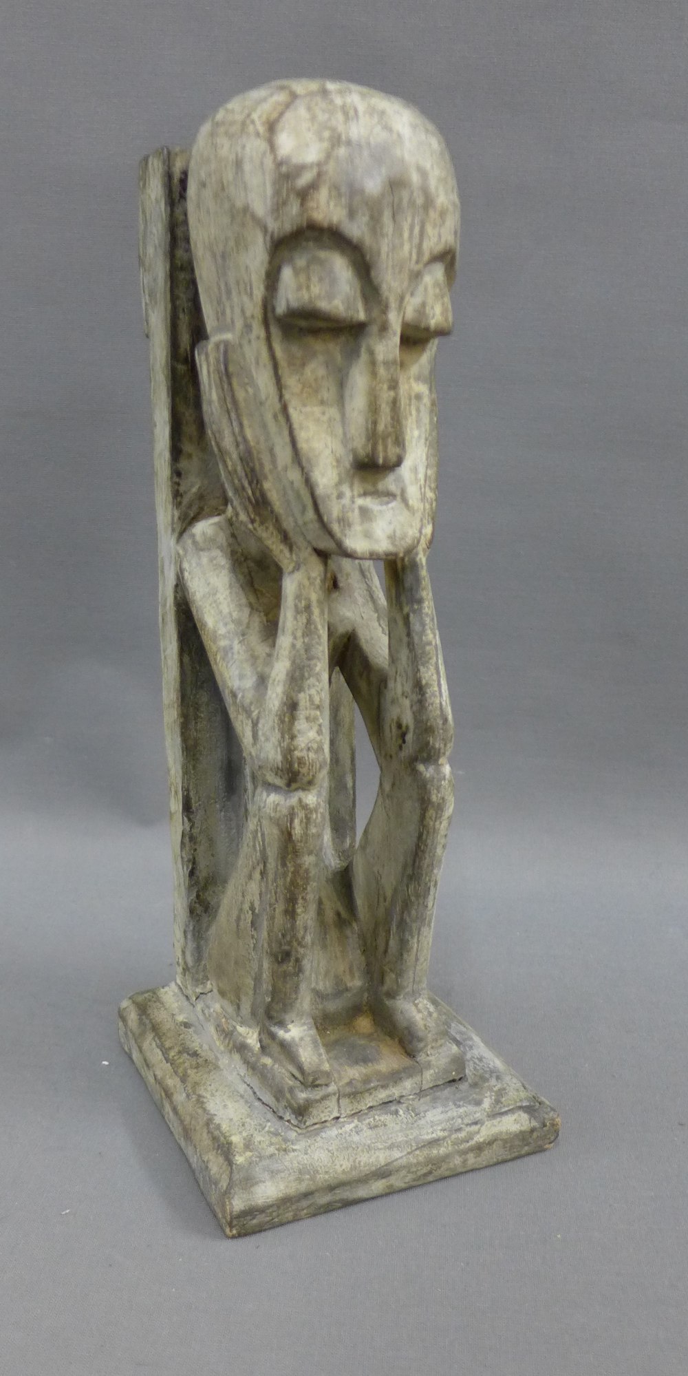 Carved wooded tribal figure, on a square base, 30cm high