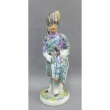 Buchan pottery style figure of a Piper, 22cm high