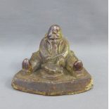 Stoneware money bank in the form of a seated man, 16cm