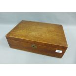 An oak box with hinged lid and brass escutcheon, 41 x 28cm