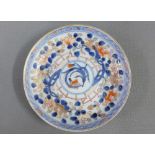 Chinese porcelain Imari pattern saucer, typically painted with flowers and foliage, (hairline crack)