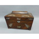 Rosewood and mother of pearl inlaid sarcophagus tea caddy, the hinged lid opening to reveal two lead