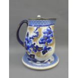 Losol Ware Pagoda pattern blue and white jug with pewter hinged lid and circular pottery stand, (2)