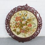 Large circular panel, likely from a pole screen, within a fretwork frame, 74 x 67cm