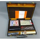 Games compendium with backgammon and draughts, etc contained within a black leather case