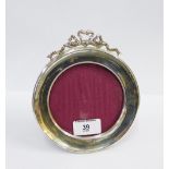 George v silver photograph frame, Birmingham 1919, of circular outline with a ribbon surmount and