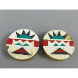 A pair of Zulu ear plugs, of circular form with red, white, green and black pattern, 7cm