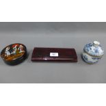 Two Japanese lacquered boxes together with a blue and white pottery jar and cover (3)