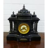 Victorian black slate mantle clock with Roman numerals to the gilt metal chapter ring, flanked by