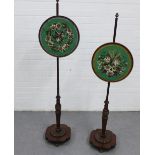 Pair of early 19th century rosewood pole screens, with carved pole, brass finials, gadrooned base,