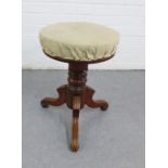 Mahogany stool on tripod legs with a circular top, 50 x 36cm
