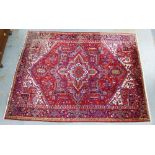 Large Persian carpet / rug, the red field with a central flowerhead medallion with geometric