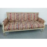 French style three seater settee with striped upholstered and painted and parcel gilt frame and