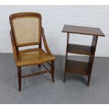 Arts & Crafts oak open bookcase with two fixed shelves and a chair with cane work back and seat,