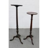 Two mahogany torchere stands, each with a circular dished top, one on a fluted column and the