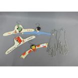 Children's vintage wooden coat hangers and a pair of metal glove stretchers, (a lot)