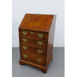 Walnut veneered secretaire chest,the fallfront with a fitted interior over pull slides, with four