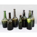 A collection of seven green glass wine bottles, tallest 33cm (7)