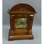Walnut cased mantle clock with a silver dial and Arabic numerals, 40cm high