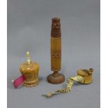 Two late 19th / early 20th century fruitwood tape measures and a needle case, tallest 10cm (3)