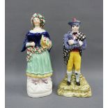 Scottish pottery figure of a Highland Gent with a Staffordshire female figure, tallest 22cm (2)