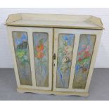 Pine ledgeback cabinet, the panelled cupboard doors Artist painted with flowers, with shelves to the