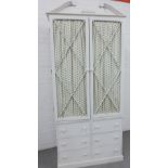 Modern white painted armoire with a broken swan neck pediment over a pair of cupboard doors with