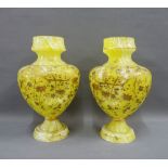 Pair of yellow opaque glass vases,of dimpled baluster form, with gilded flowers and foliage, on a