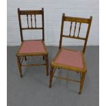 A pair of early 20th century oak framed side chairs with pink upholstered seats, 86 x 40cm (2)