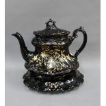 Victorian black glazed Jackfield style teapot with stand, 20cm high