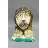 19th century Staffordshire sash window support, modelled as a lion in coloured enamels, 12cm high