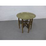 Benares style table with a circular brass tray top, 58 x 59cm