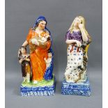 Two Scottish pottery figures - Charity and Hope, each modelled standing on a blue rectangular rope