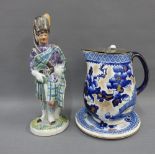 Scottish pottery figure of a Piper and a Losol Ware flow blue and white jug and stand, (3)