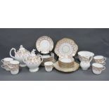 Late 19th century porcelain teaset wit a white glazed ground, pink border and gilded flowers, (38)