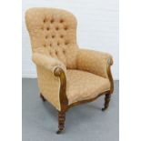 Feather pattern button back upholstered armchair with mahogany frame and brass caps and castors, 102