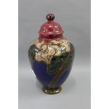 Rozenburg Den Haag pottery vase and cover, painted with stylised flowers and foliage, with printed