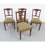 Set of four mahogany side chairs with floral carved top rails and vertical splats, upholstered seats