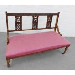 Mahogany framed two seater hall settee, with a foliate carved top rail, vertical splat back and pink