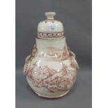 Large continental pottery jar and cover with loop handles to side, painted with a hunting dog and