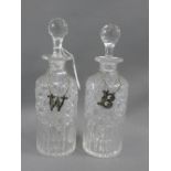 A pair of cut glass spirit decanter and stoppers, together with Epns W & B decanter labels, 26cm