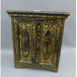 Chinoiserie black lacquered papier mache cabinet, the gilt patterned doors opening to reveal a set