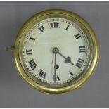 Ships clock in a brass and steel case, with Roman numerals to the enamel dial, overall diameter 19cm