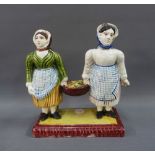 East Coast Scottish pottery figure group of two fishwives, each modelled standing on a rectangular