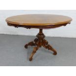 Mahogany pedestal table with carved column and quadruple legs, 77 x 123cm