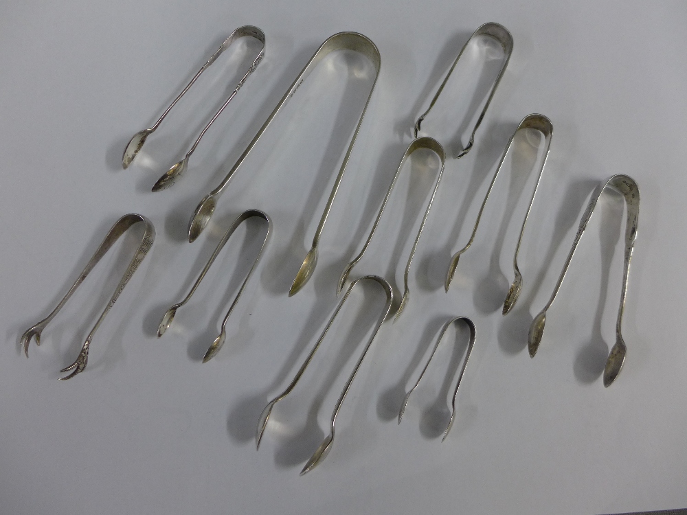 A collection of eight silver sugar tongs with mixed hallmarks together with a pair of Epns sugar
