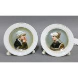 Two handpainted porcelain plaques of circular outline, 6.5cm diameter (2)