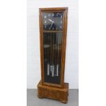 WITHDRAWN Art Deco walnut long case clock, the square black dial with silvered Arabic numerals